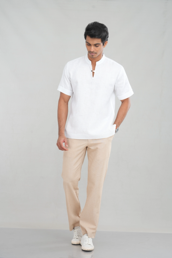 A model wearing a Classic Crisp White shirt made of lightweight linen, perfect for casual summer outings or versatile everyday styling.