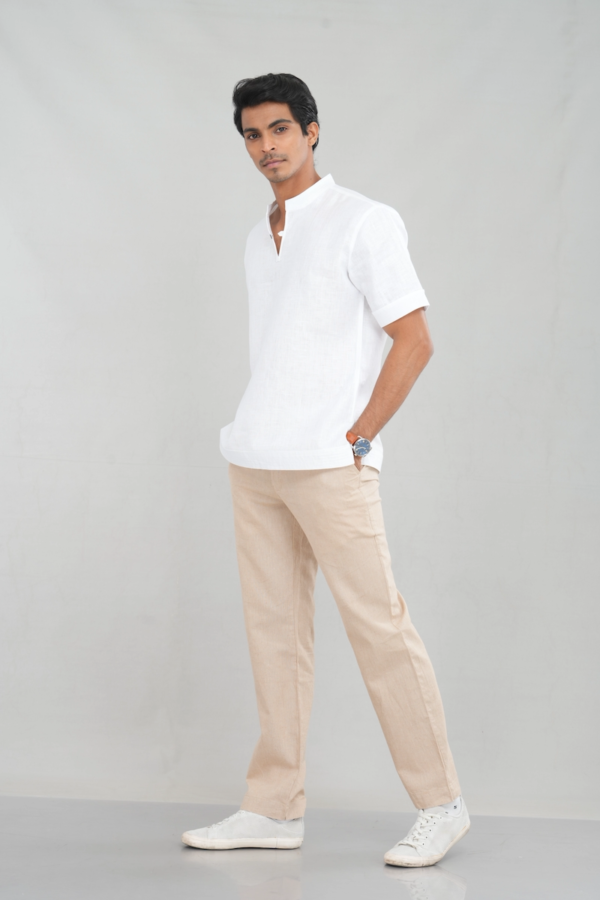 A model wearing a Classic Crisp White shirt made of lightweight linen, perfect for casual summer outings or versatile everyday styling.