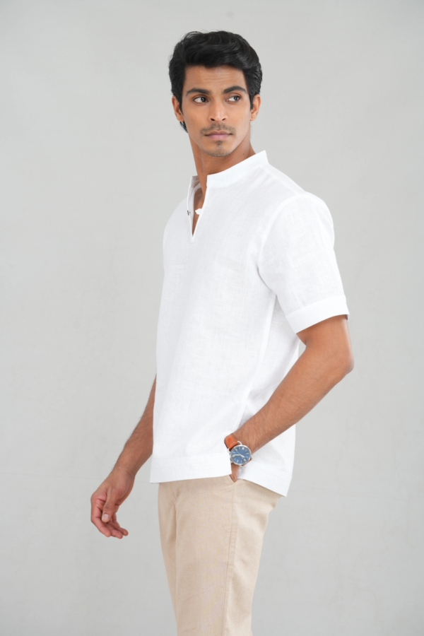 A model wearing a Classic Crisp White shirt made of lightweight linen, perfect for casual summer outings or versatile everyday styling.