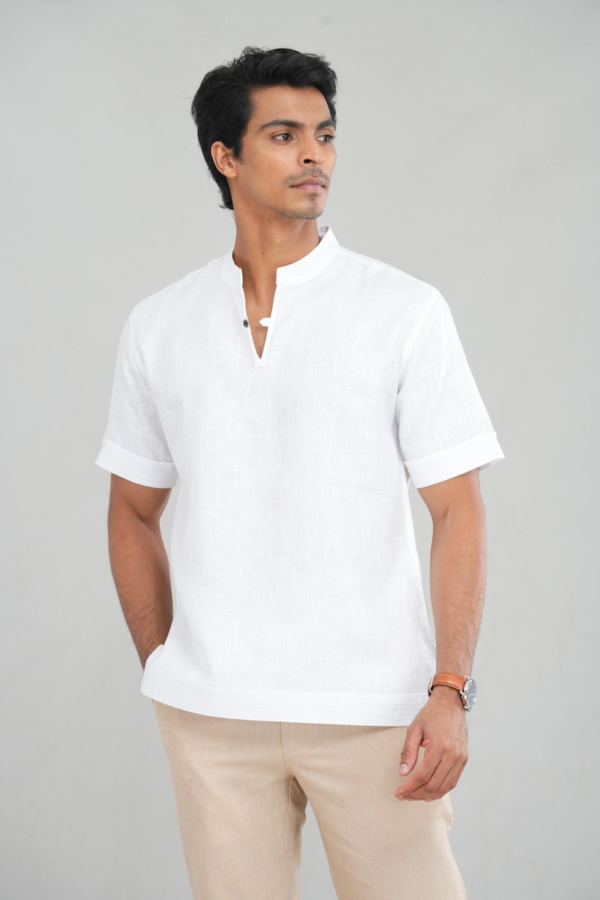 A model wearing a Classic Crisp White shirt made of lightweight linen, perfect for casual summer outings or versatile everyday styling.