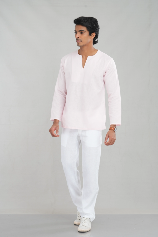 A model wearing a blush pink linen-cotton blend kurta shirt with long sleeves and a simple V-neckline, perfect for casual ethnic wear or versatile everyday outfits