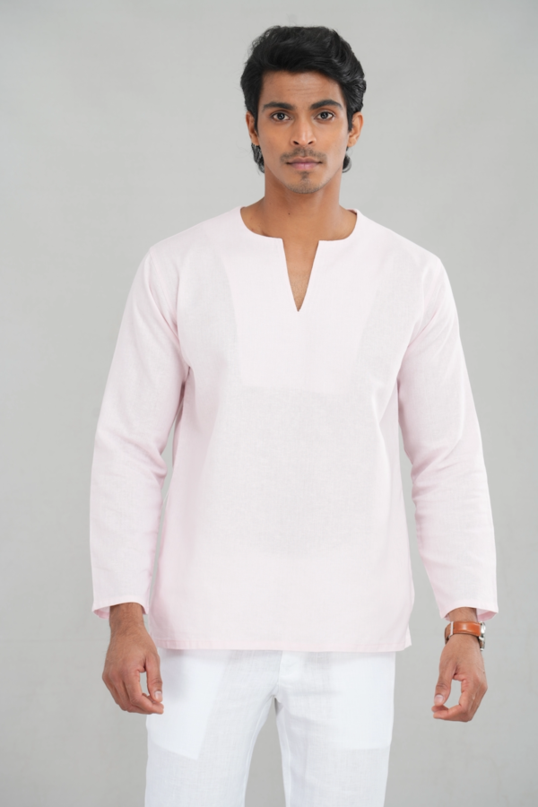 A model wearing a blush pink linen-cotton blend kurta shirt with long sleeves and a simple V-neckline, perfect for casual ethnic wear or versatile everyday outfits