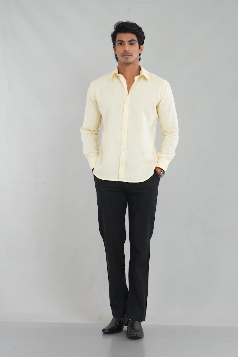 A model wearing a Lemon Pastel Linen shirt with long sleeves and a classic button-up design, perfect for casual summer wear or elegant everyday styling.