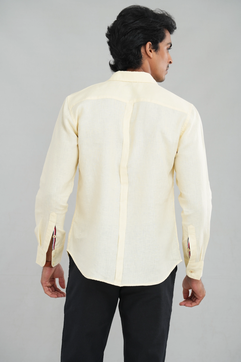 A model wearing a Lemon Pastel Linen shirt with long sleeves and a classic button-up design, perfect for casual summer wear or elegant everyday styling.