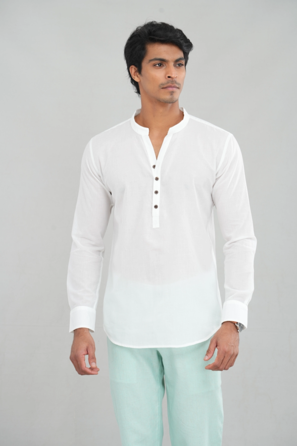 A model wearing a pure white linen kurta shirt with long sleeves and a buttoned placket, perfect for casual ethnic wear or stylish everyday outfits.