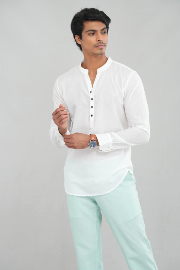 A model wearing a pure white linen kurta shirt with long sleeves and a buttoned placket, perfect for casual ethnic wear or stylish everyday outfits.