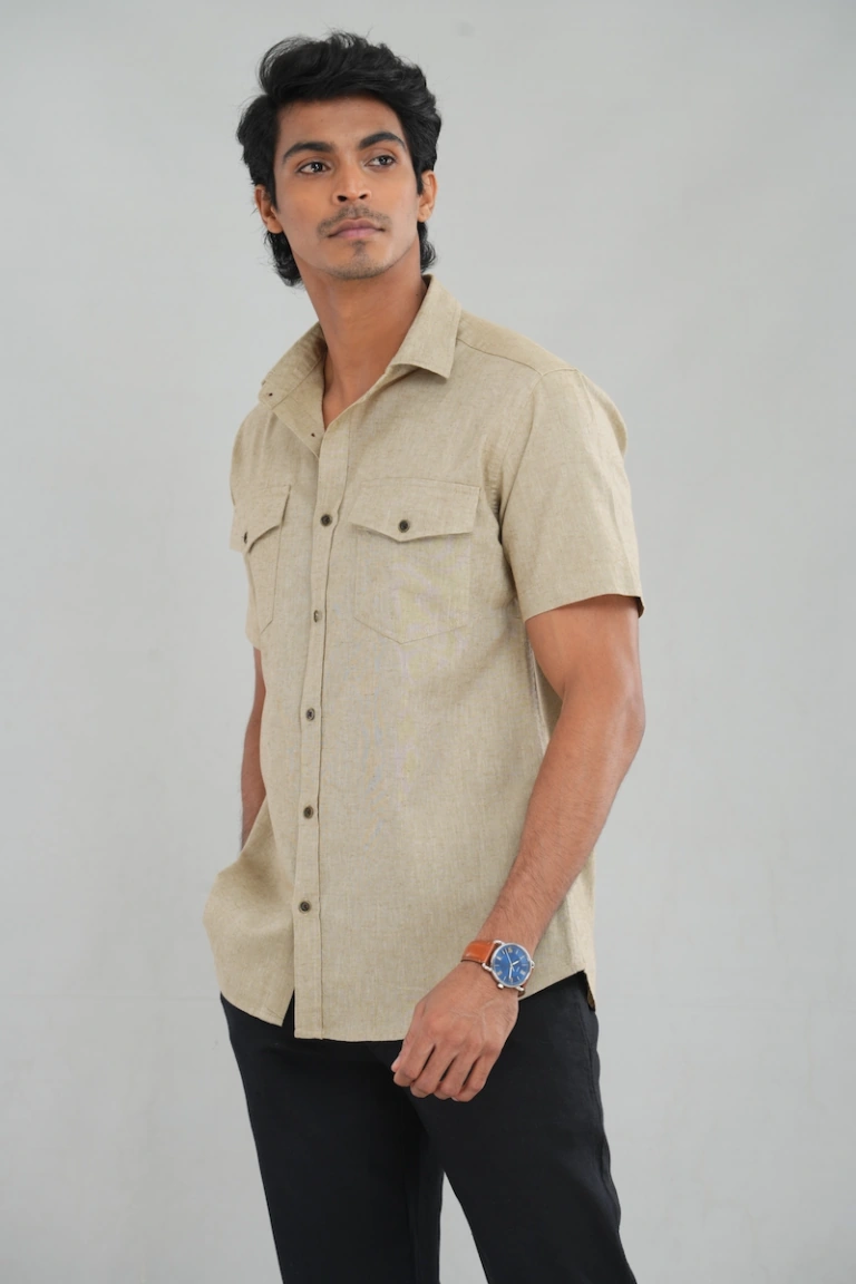 A model wearing a Sandy Beige Linen-cotton shirt with buttoned chest pockets, classic collar design, and lightweight fabric, perfect for casual summer wear or everyday styling.