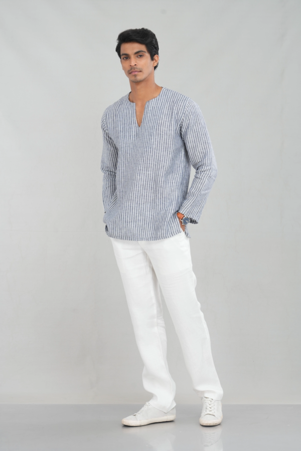 A model wearing a navy striped linen kurta shirt with long sleeves and a relaxed V-neckline, offering a stylish and breathable choice for ethnic and casual occasions.