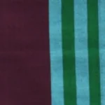 Handloom cotton sarong in deep burgundy with a vertical panel of vibrant aqua and green stripes, hanging on a rack.