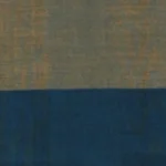 Handloom cotton sarong in muted khaki with wide navy blue and sky blue horizontal stripes at the hem, hanging on a rack.