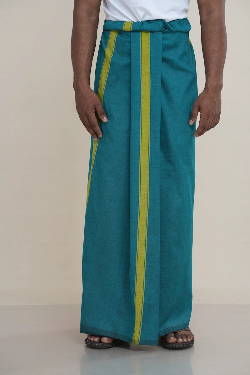 Man wearing a deep teal handloom cotton sarong with two vertical lime green stripes.
