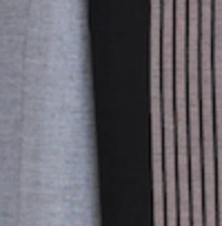 Man wearing a light grey handloom cotton sarong with a wide black vertical panel featuring fine pink pinstripes.