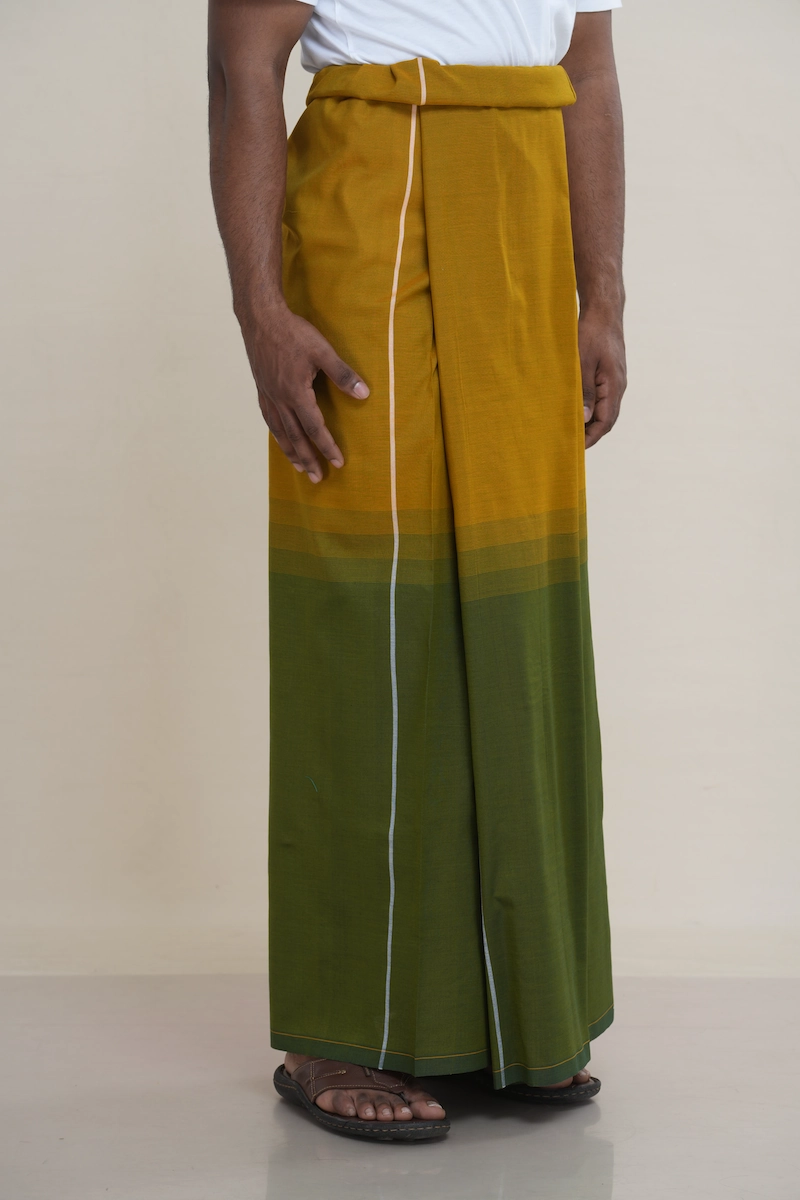 Man wearing a handloom cotton sarong with a mustard to olive green ombré gradient and a central white pinstripe.