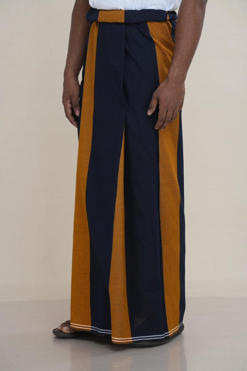 Man wearing a navy blue handloom cotton sarong featuring a prominent wide vertical mustard stripe.