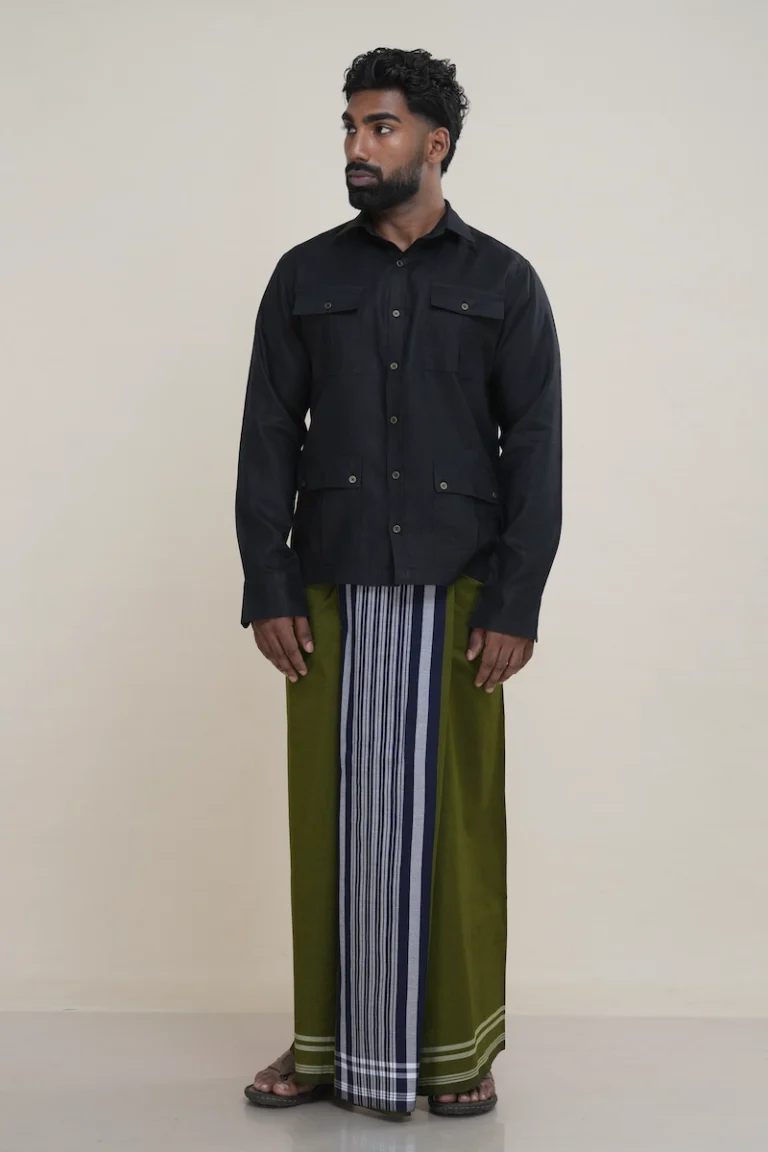 Man wearing a traditional olive green handloom cotton sarong with a vertical navy and white striped panel.man wearing an olive green handloom cotton sarong, showing the wrap and striped detail.