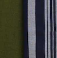 Man wearing a traditional olive green handloom cotton sarong with a vertical navy and white striped panel.man wearing an olive green handloom cotton sarong, showing the wrap and striped detail.