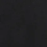 Man wearing a black tonal linen shirt featuring a white stripe contrast inner collar and black buttons, paired with blue jeans.