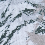 Close-up of a men's cotton Mandarin collar short sleeve shirt with a light grey base and green botanical print, featuring coconut buttons.