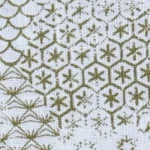 Man wearing a Cotton short sleeve shirt with an olive green geometric print, double placket, and chest pocket.