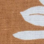 Man wearing a terracotta linen cotton blend Cuban collar shirt with a white pineapple and palm tree print. Close-up of a terracotta and white tropical print Cuban collar shirt highlighting the print detail and collar style.