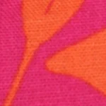 Woman wearing a hot pink and orange botanical print cotton crop top, featuring a high neckline and a full button-back closure.