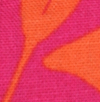 Woman wearing a hot pink and orange botanical print cotton crop top, featuring a high neckline and a full button-back closure.