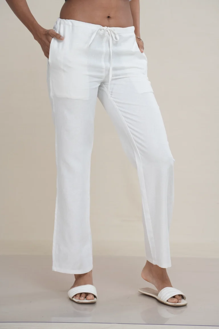 Woman wearing classic white linen-cotton blend drawstring lounge pants with front patch pockets.