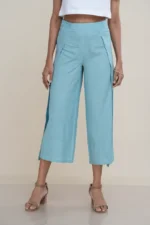 Woman wearing light turquoise linen-cotton blend wide-leg culottes with a high side slit, showcasing movement, the elegant high side slit detail on light turquoise wide-leg cropped pants.