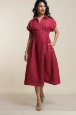 Women's crimson red linen midi dress with collar, short sleeves, cinched waist and pleated skirt, front view on model