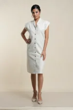 Front view of ecru linen cotton blend button-front shirt dress with collar, cap sleeves, and knee-length cut on model