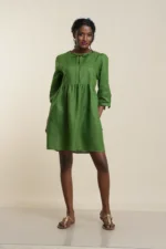Women's empire waist linen dress in leaf green with long sleeves, tie neck detail, and knee-length gathered skirt
