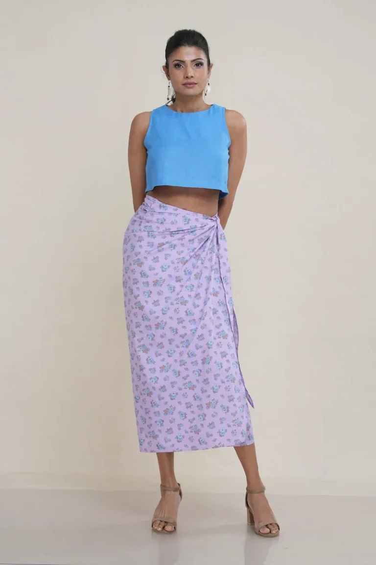 Women's wrap skirt in lilac with ditsy floral print, 100% cotton fabric, styled with blue crop top, front view