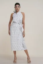 Woman wearing white cotton wrap skirt with olive green geometric print, styled with tie waist and gold sandals